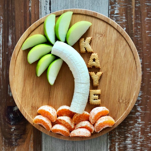chick-chicka-boom-boom-snack-idea-with-fruit - The Educators' Spin On It Coconut Tree Snack with apples leaves, banana stem and oranges for sand along with letter crackers