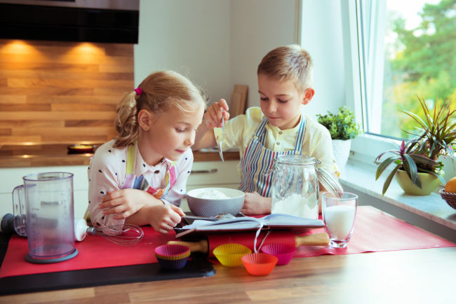 child-making-muffins-in-kitchen - The Educators' Spin On It Child making muffins in kitchen