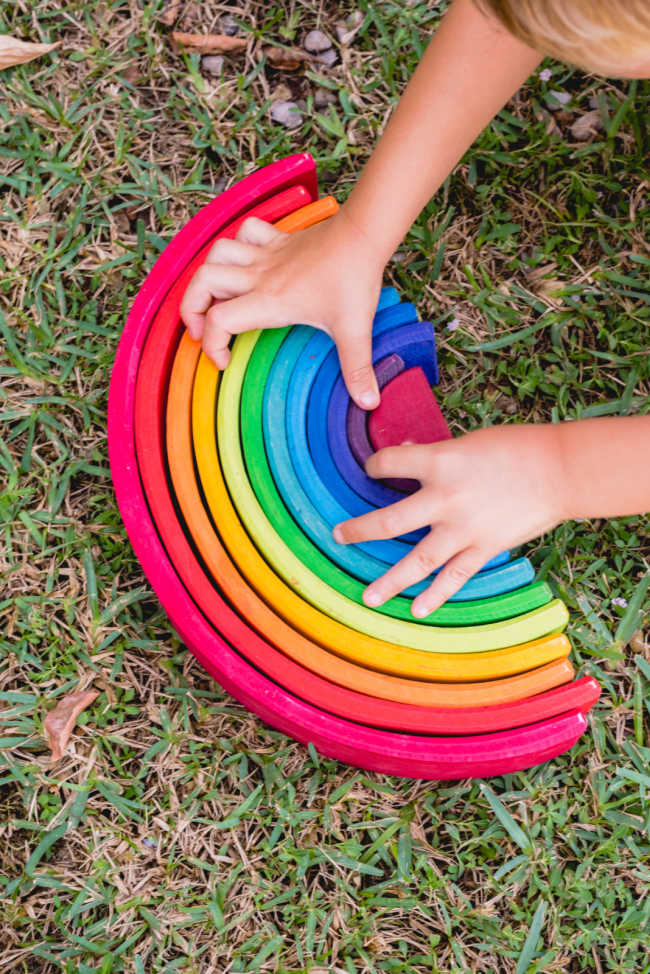 child-playing with-rainbow-toy - The Educators' Spin On It Child playing with Rainbow Toy