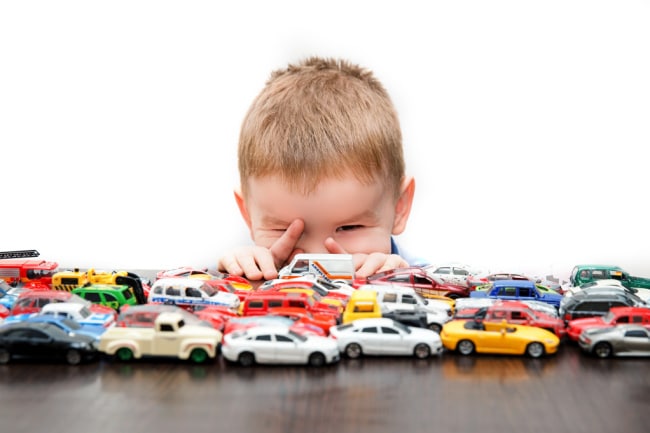 child-with-toy-cars - The Educators' Spin On It Boy playing with collection of toy cars