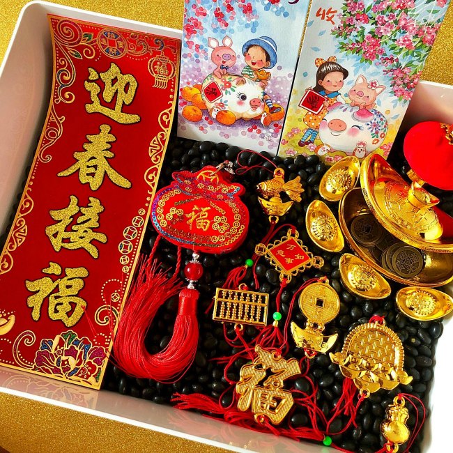 chinese-new-year-sensory-bin - The Educators' Spin On It Chinese New Year Sensory Bin with Black Beans and Golden items and red envelope