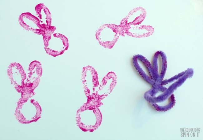 Create your own Bunny Stamp Paint Activity with Preschoolers - The Educators' Spin On It Pink paint outline of rabbit from bunny outline with pipe cleaner for Kids