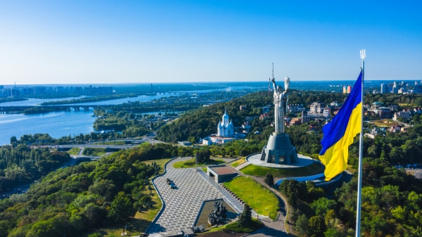 Motherland-Monument-Ukraine- - The Educators' Spin On It Aerial view of the beautiful landscape city Kyiv with a Dnepr river. Includes view of the Motherland statue in Kyiv. The national flag of Ukraine.