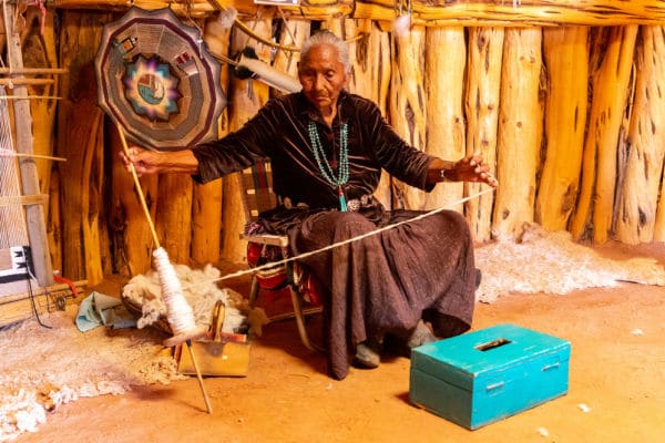 native-american-making-wool-yarn-for-weaving - The Educators' Spin On It Old Navajo woman in Navajo nation reservation at Monument Valley, Arizona, USA