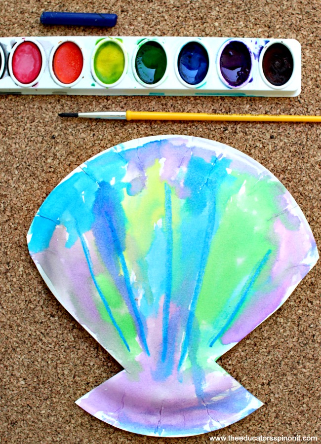 Watercolor Seashell craft idea for your toddler or preschooler. We're sharing 4 simple ideas that you can do at your next playdate. Fun and easy hands on ideas all about the ocean. Watercolor paint with watercolor seashell art project made by a toddler or preschooler