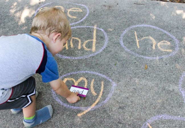 Sidewalk Chalk Sightword Game for Kids-9858 - The Educators' Spin On It Child learning to read sight words while playing a sidewalk chalk sight word game