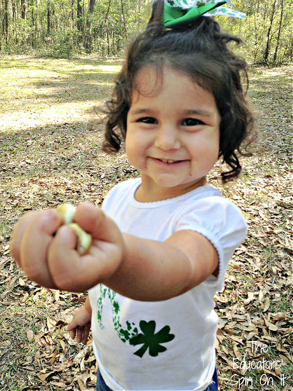 St.-Patricks-Day-Tot-School-Gold-Hunt - The Educators' Spin On It Child holding Gold from St. Patrick's Day Tot School Activities
